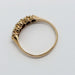 Side view of 15kt yellow gold ring with five seed pearls in prong setting