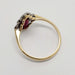 Side profile of 18kt gold Art Deco ring with red glass stones and diamond details
