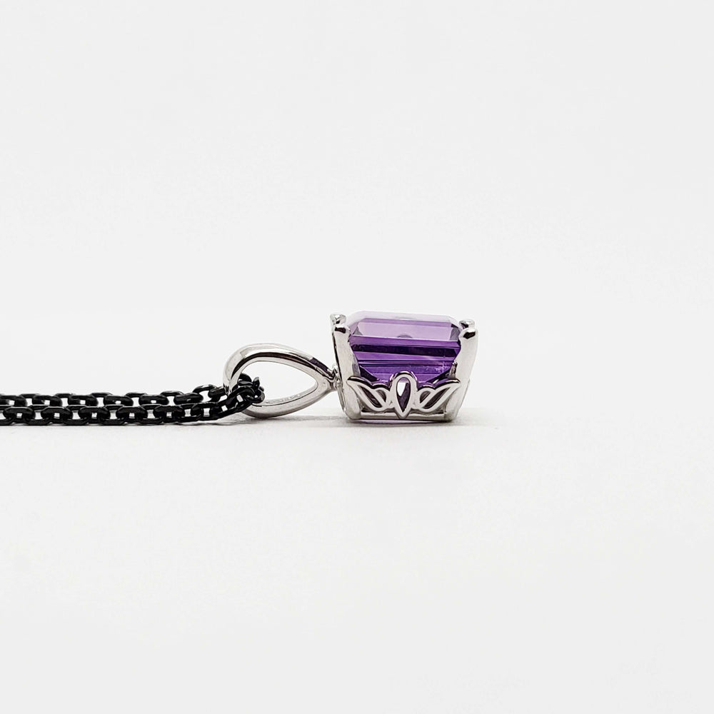 Side profile of emerald cut amethyst pendant in 14kt white gold showing detailed setting