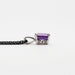 Side profile of emerald cut amethyst pendant in 14kt white gold showing detailed setting