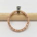 Side view of engraved 14kt rose gold ring with teal Australian sapphire in white gold setting