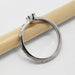 Side view of engraved 14kt white gold ring with marquise lab diamond on pencil