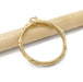 Side view of 14kt yellow gold engagement ring with engraved band resting on a pencil