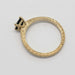 Profile of engraved 14kt yellow gold ring with green asscher cut sapphire