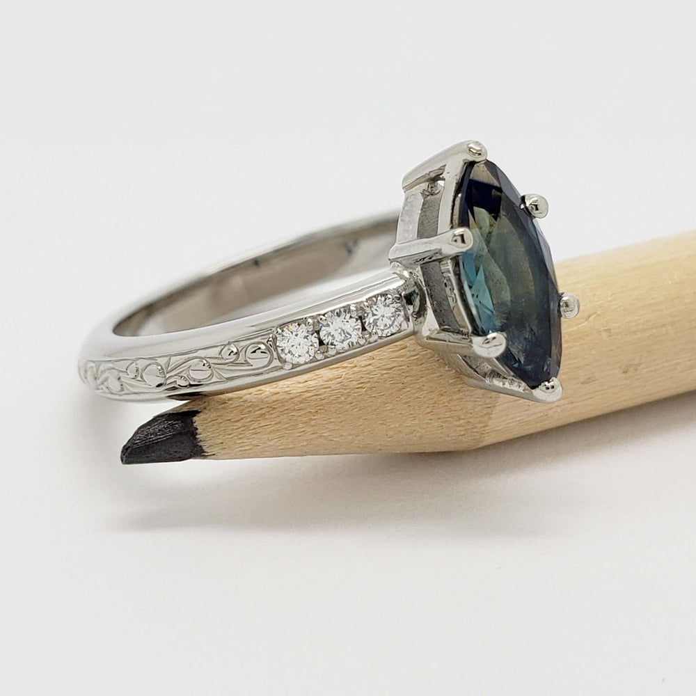 Side view of engraved white gold ring with marquise Australian sapphire and Canadian diamonds