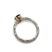 Side profile of engraved white gold ring with yellow gold setting and pink-purple sapphire