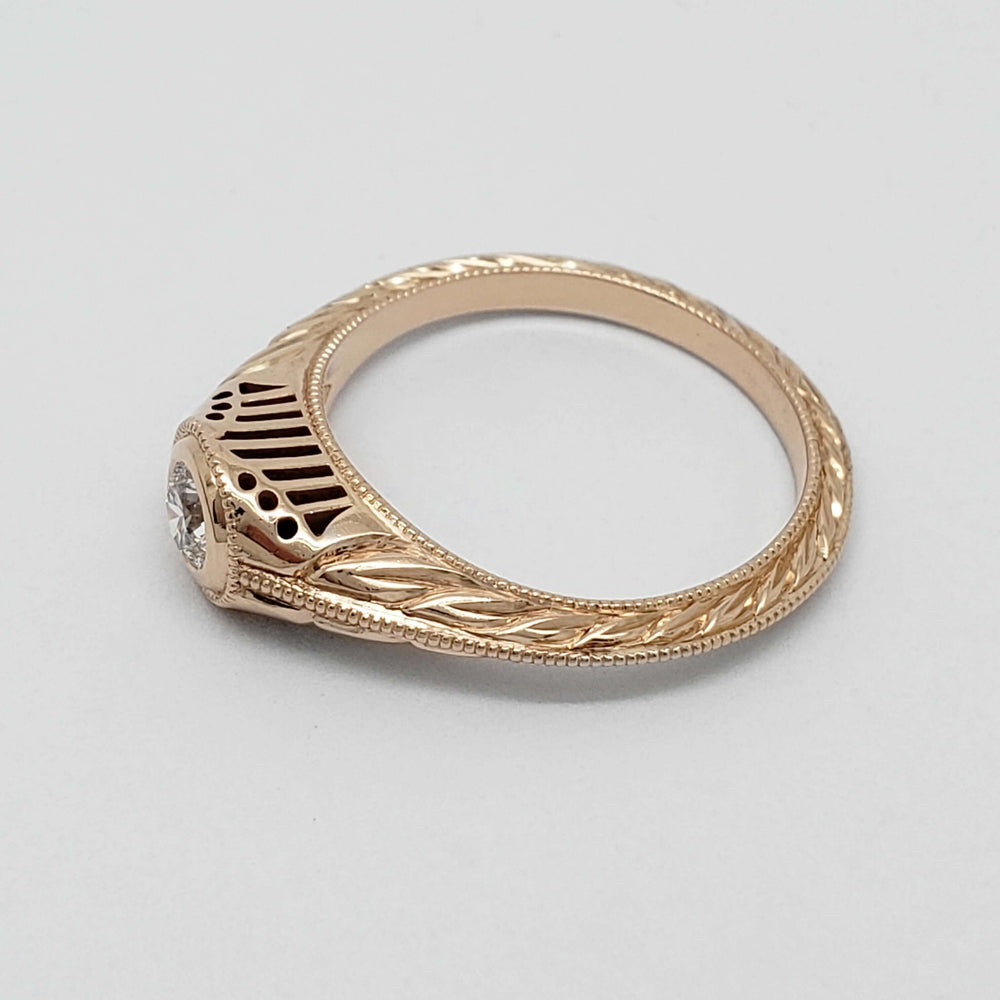 Side view of hand engraved 14k rose gold diamond ring with intricate filigree