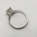 Side view of platinum engagement ring with detailed engraving and millgrain edges