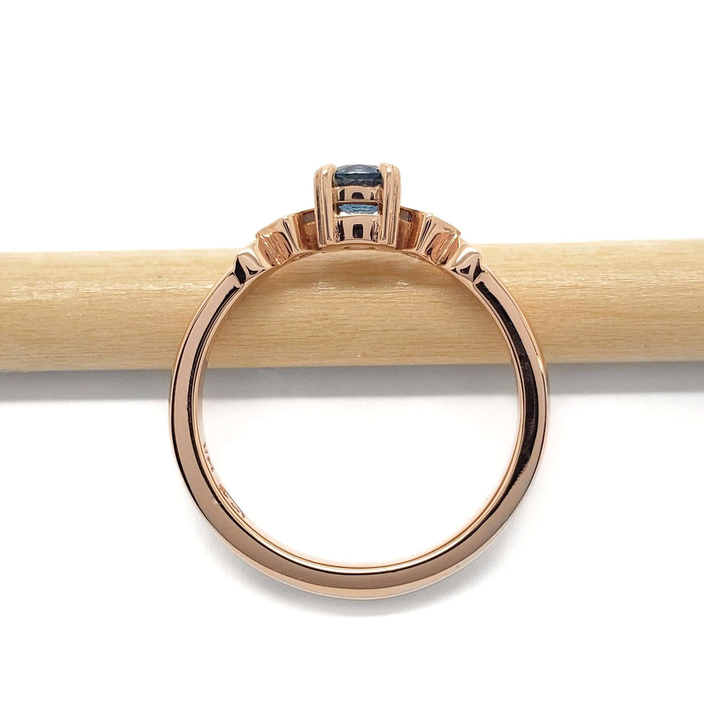 Side profile of 14kt rose gold Montana sapphire and diamond ring showing setting details