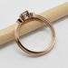 Side view of rose gold ring with blue Montana sapphire and diamonds, showing band detail