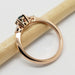 Side view of 14kt rose gold Montana sapphire and lab diamond ring on a pencil