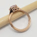 Side view of rose gold ring with cushion cut pink sapphire and intricate gallery