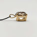 Side profile of smoky quartz pendant set in 14kt yellow gold with black chain