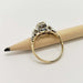 Side view of two-tone diamond engagement ring on a pencil showing band and setting