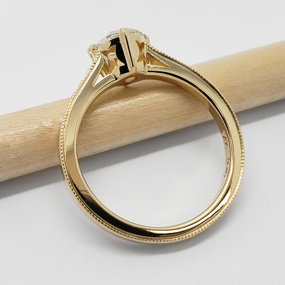 Side view of vintage-inspired yellow gold engagement ring with rose cut lab diamond