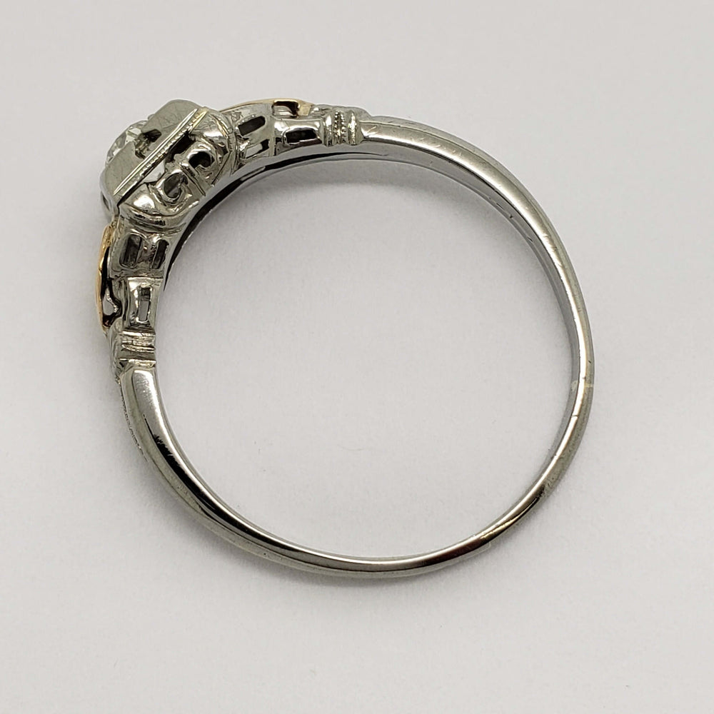 Side view of vintage 14kt white and yellow gold diamond ring with openwork details
