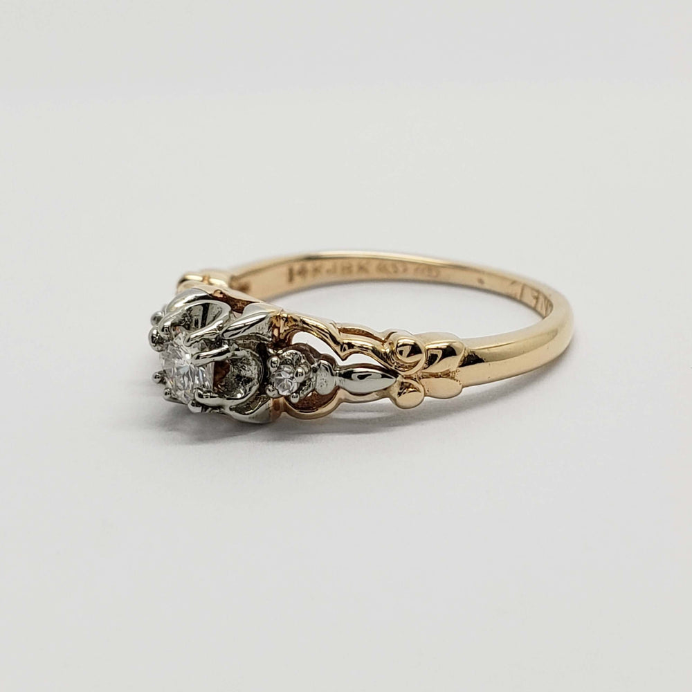 Side profile of vintage two-tone gold diamond ring with detailed setting