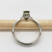 Side view of white gold ring with basket-set Australian sapphire on a pencil