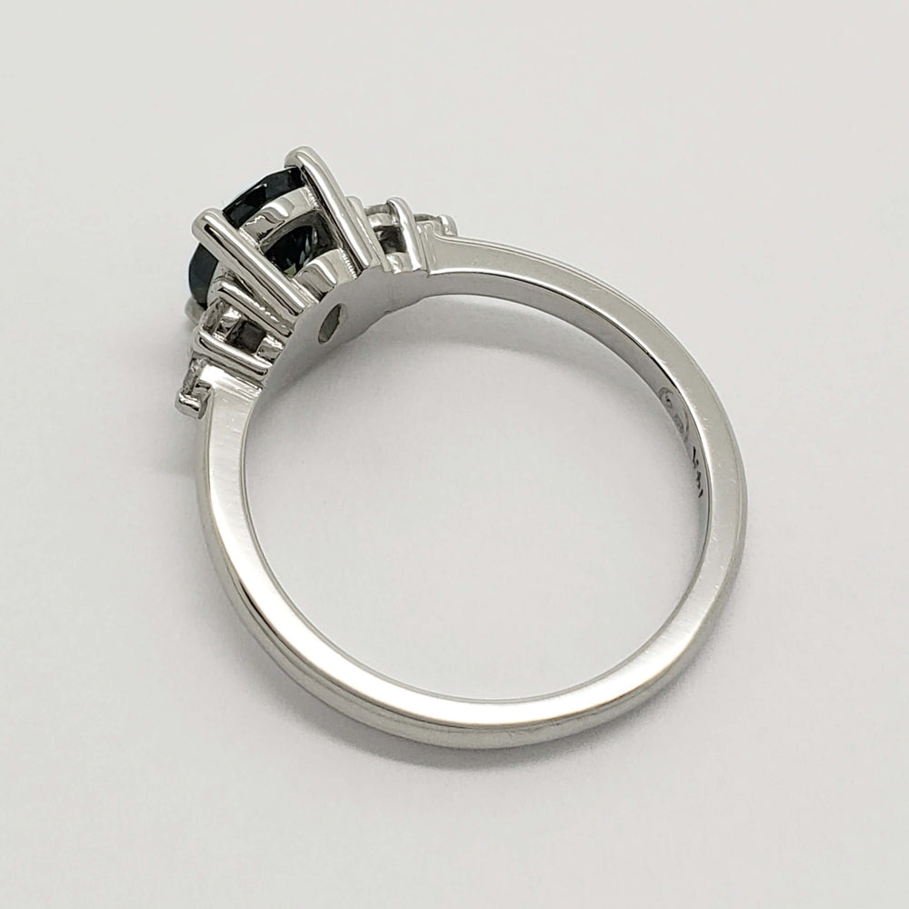 Side profile of white gold ring showing sapphire and diamond setting