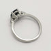 Side profile of white gold ring showing sapphire and diamond setting