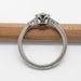 Side view of white gold ring with millgrain detail and cutout gallery, no stone visible