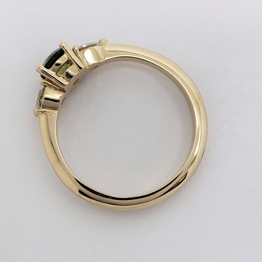 Side profile of yellow gold ring showing setting of Montana sapphire and lab diamonds