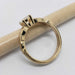 Side view of yellow gold engagement ring with millgrain detail and round lab diamond