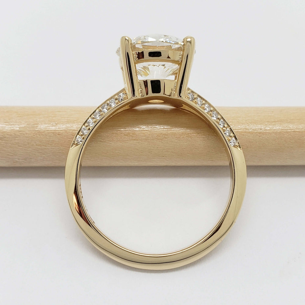 Side view of yellow gold engagement ring with pave-set lab diamonds on split shank band