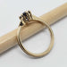 Side view of yellow gold engagement ring with purple sapphire and millgrain detail