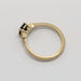 Side profile of yellow gold engagement ring with sapphire and diamond detailing