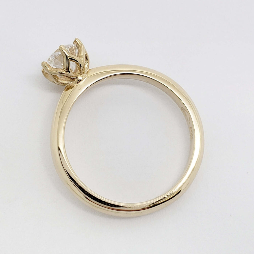 Side view of yellow gold ring showing the delicate tulip-style diamond setting