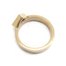 Side view of yellow gold ring showing the solid band and bezel-set sapphire