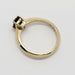 Side view of yellow gold ring with emerald cut blue Montana sapphire