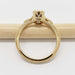 Side view of yellow gold ring with milgrain detail and cutout setting, no stone visible