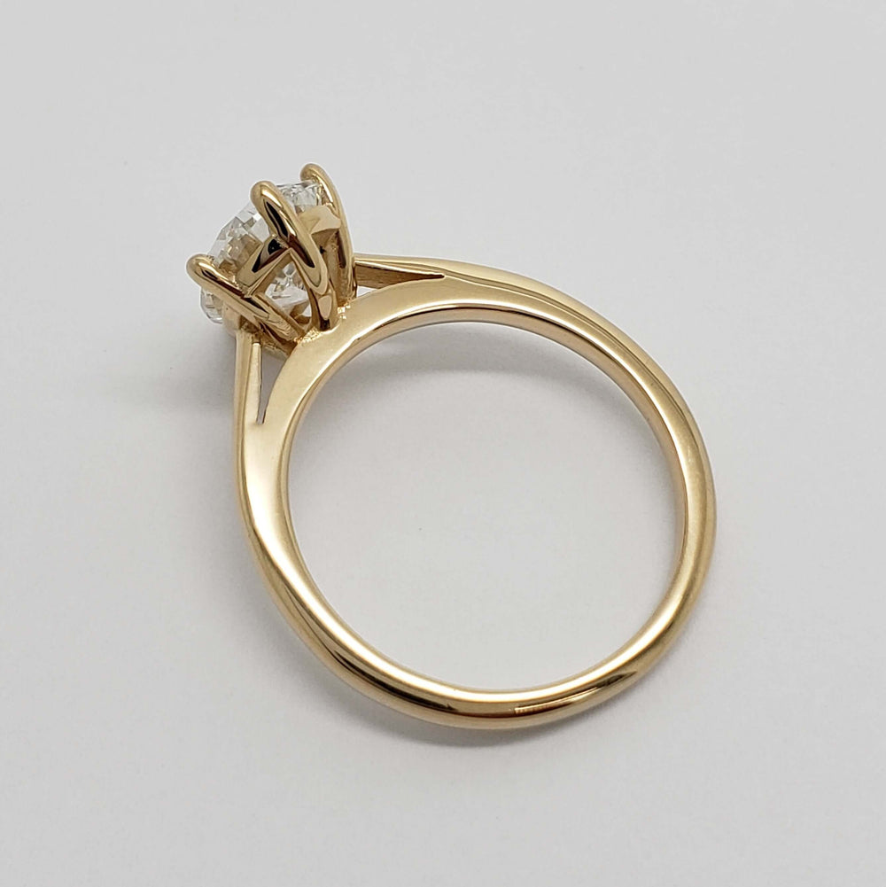 Side profile of yellow gold ring with high-set pear lab diamond