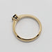 Side view of yellow gold ring showing prong-set blue Montana sapphire