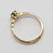 Side view of 14kt yellow gold ring showing sapphire setting and polished band