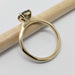 Side view of yellow gold ring with teal Australian sapphire and four-prong setting