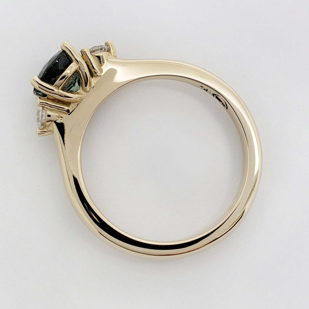 Side view of yellow gold ring with teal Australian sapphire and lab diamonds
