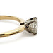 Side view of yellow gold ring with white gold six-prong setting and round diamond