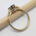 Side profile of 14kt yellow gold ring with oval sapphire and diamond accents