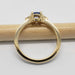 Side profile of yellow gold ring with blue sapphire and diamond accents
