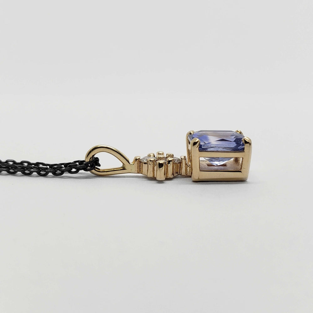 Side profile of yellow gold pendant with radiant blue sapphire and lab diamonds