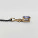 Side profile of yellow gold pendant with radiant blue sapphire and lab diamonds