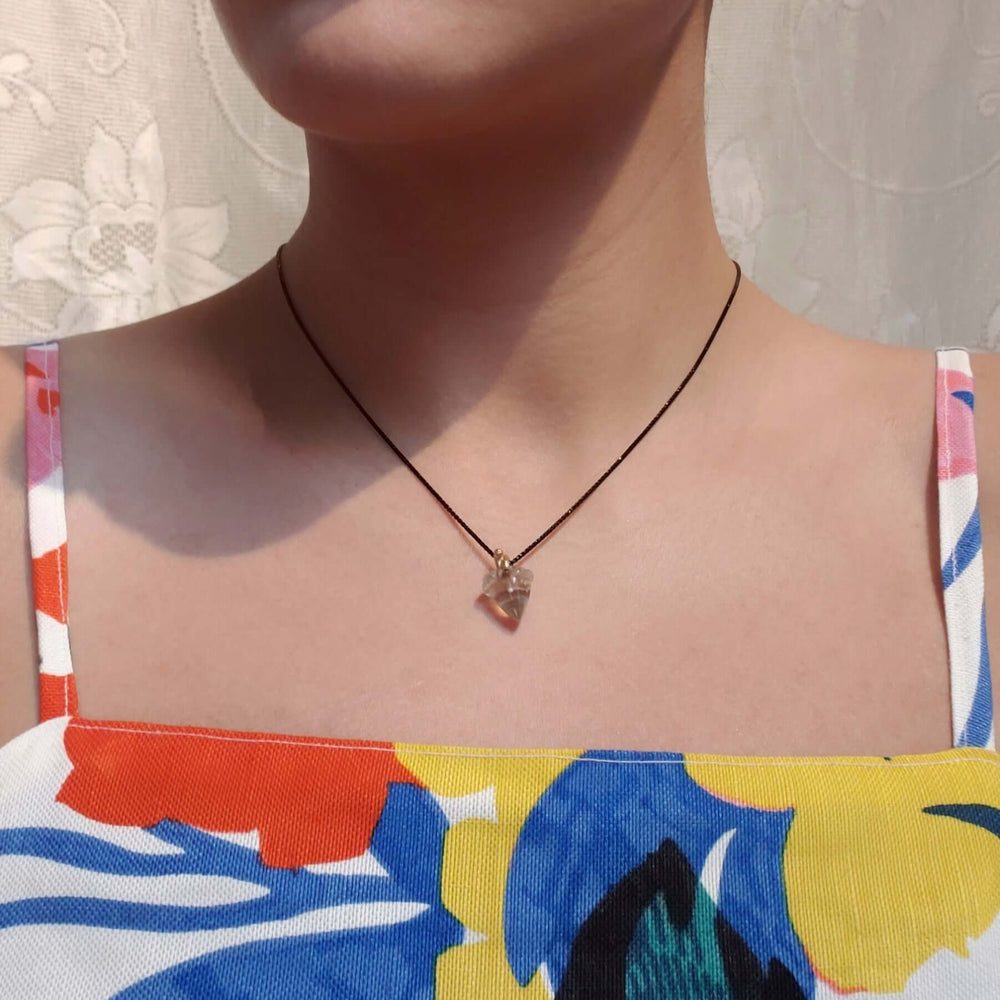 Small smoky quartz acorn pendant with 14kt gold bail worn on a necklace