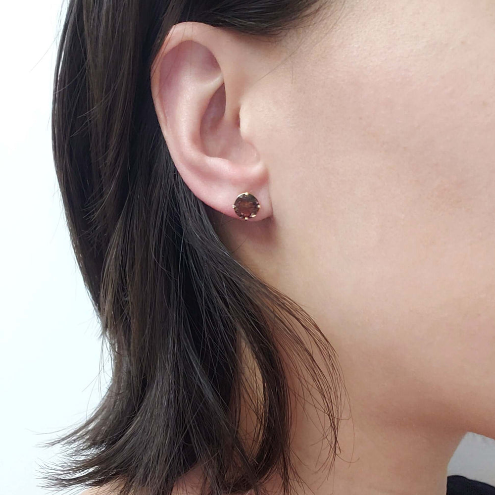 Smoky quartz stud earring in yellow gold worn on ear