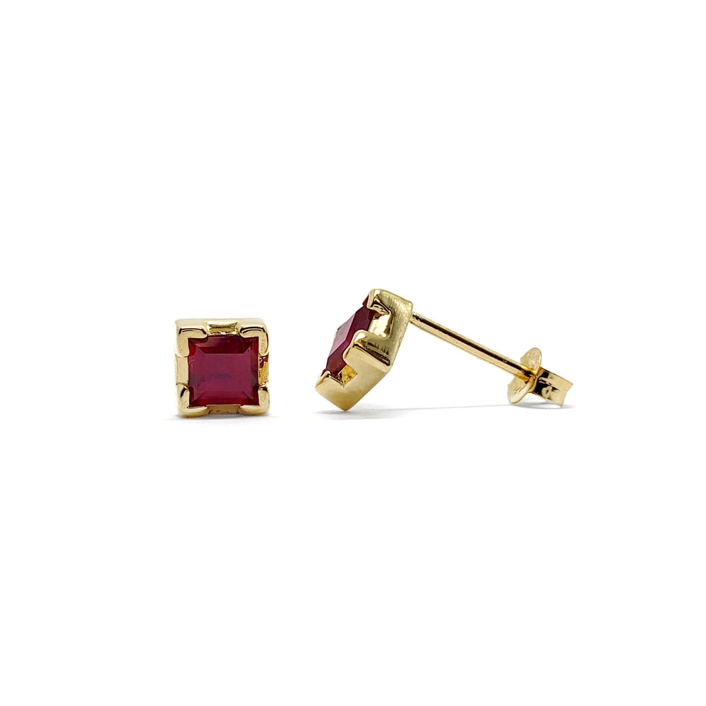 Pair of square step cut lab ruby stud earrings in 14kt yellow gold on white background