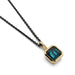 Square teal tourmaline bezel pendant in 14kt yellow gold on a black chain, close-up