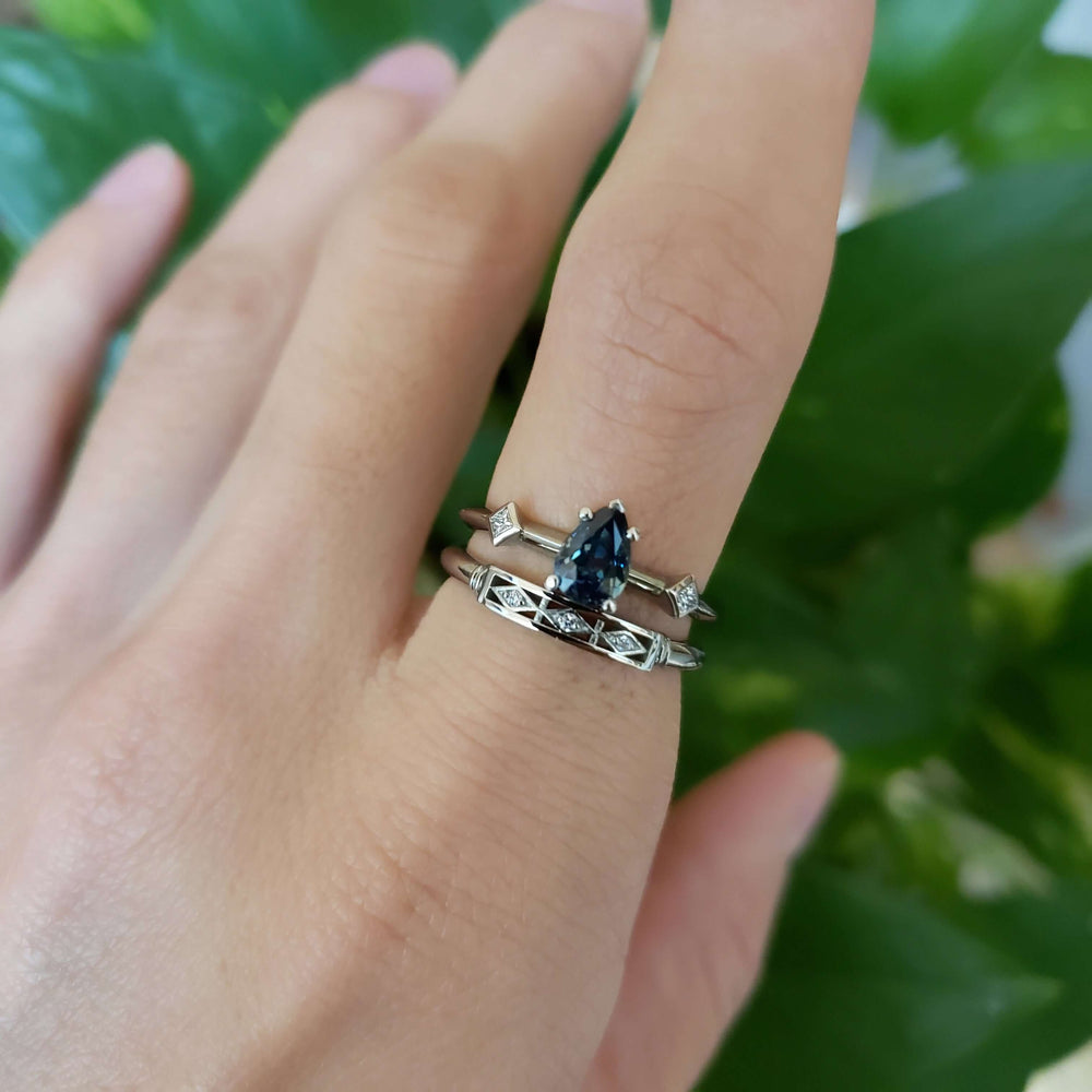 Stacked rings on hand: 14kt white gold Art Deco wedding ring with Canadian diamonds and sapphire engagement ring