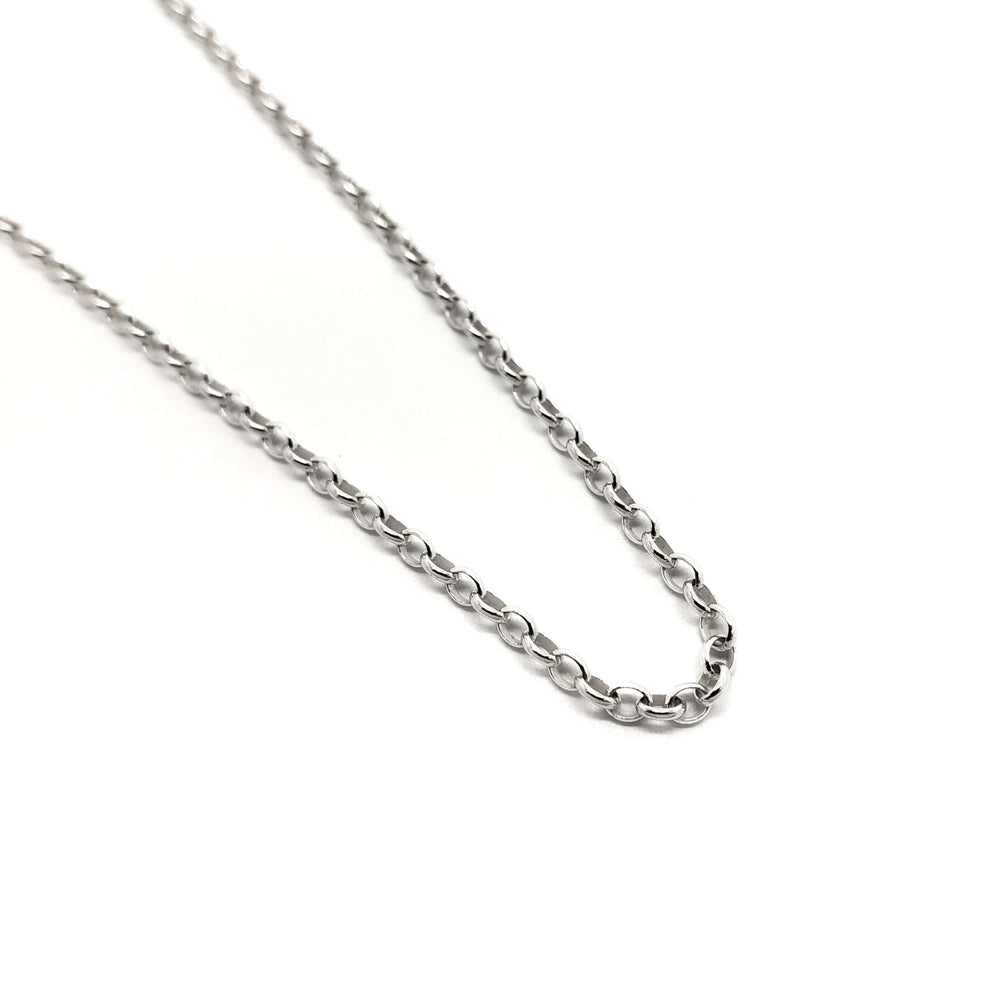 Sterling silver cable chain necklace with round links on a white background